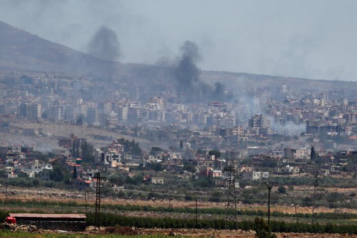 Smoke rise from clashes between Syrian government forces and Druze militias in Sweida city, southern Syria on Tuesday.
