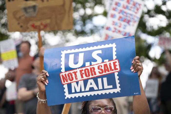 A demonstrator holds a sign that says "U.S. MAIL NOT FOR SALE" during an April protest in Columbia, S.C.