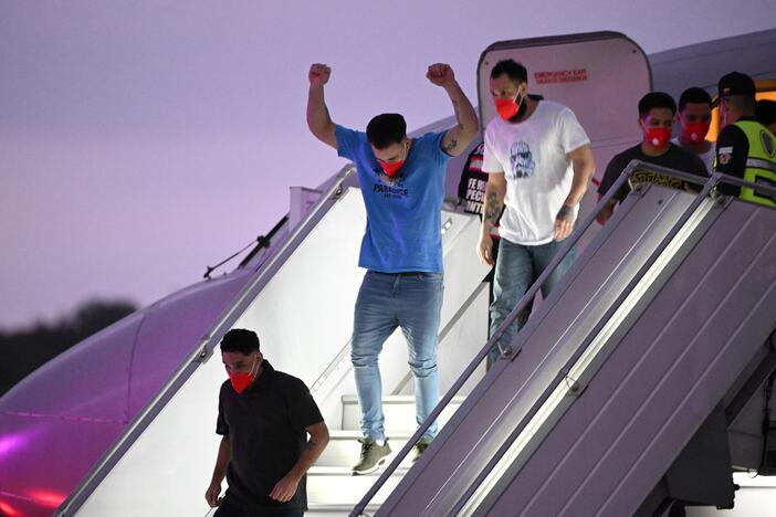A Venezuelan migrant who was jailed in El Salvador gestures as he gets off a plane at Simon Bolívar International Airport in Maiquetía, Venezuela on Friday. El Salvador freed scores of Venezuelans deported from the United States to a notorious maximum security prison, the outcome of a highly coordinated prisoner swap between Caracas and Washington.