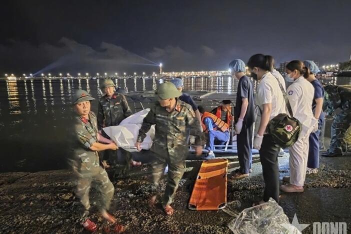 This image from a video provided by QDND shows a body being carried on stretcher after a tourist boat capsized in Ha Long Bay, Vietnam on Saturday, July 19, 2025.
