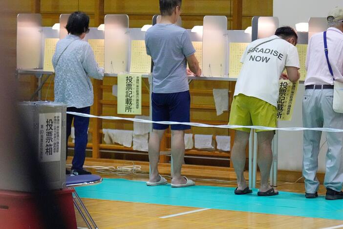 Voters fill in their ballots in the upper house election at a polling station Sunday, July 20, 2025, in Tokyo.