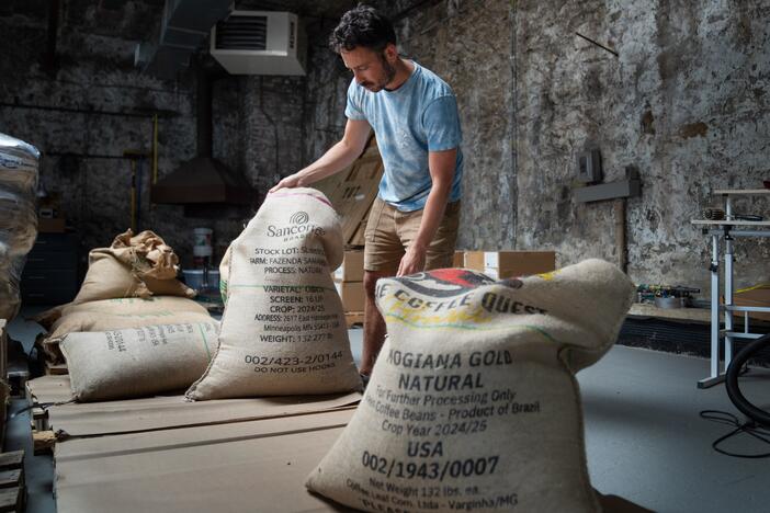 Jeff Yerxa, co-owner of Lost Sock Roasters, shows bags of coffee beans, many from Brazil, at the company's warehouse in Washington, D.C. The looming threat of a 50% tariff on all goods from Brazil — the world's largest coffee producer — has sent shock waves through the U.S. coffee industry.