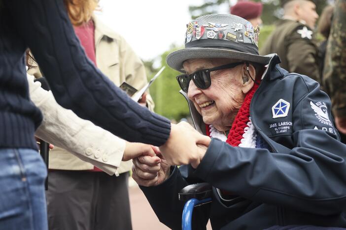 World War II veteran Jake Larson meets youths during ceremonies at the US cemetery to commemorate the 81st anniversary of the D-Day landings, on June 6, 2025 in Colleville-sur-Mer, Normandy.