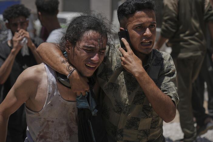 Palestinians react after carrying the bodies of those killed while trying to reach aid trucks entering northern Gaza through the Zikim crossing with Israel, at Shifa Hospital in Gaza City, on Sunday.
