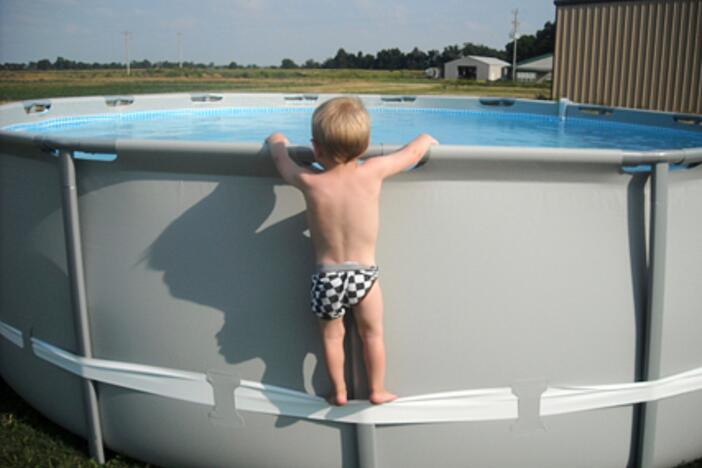 In this undated image provided by the CPSC, a child uses the compression strap to stand on above-ground pool. (CPSC via AP)