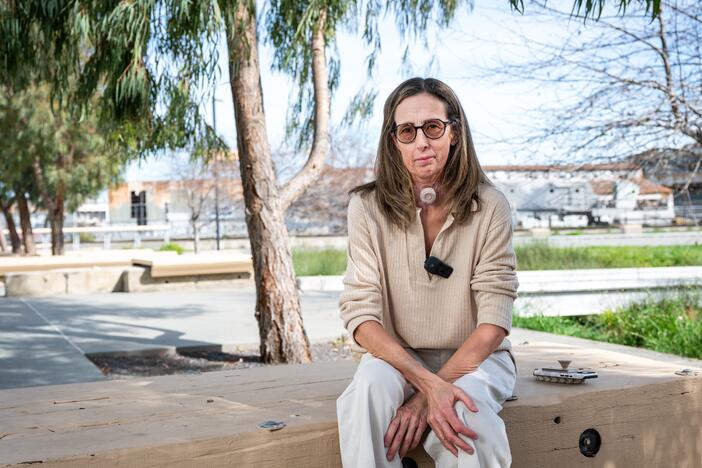 Sonya Sotinsky sits at Crane Cove Park in San Francisco on March 25. Sotinsky was diagnosed with Stage 4 tongue cancer and underwent surgery to remove her tongue, larynx and other structures. She then worked with researchers to create an AI-generated voice using past recordings of her speech.