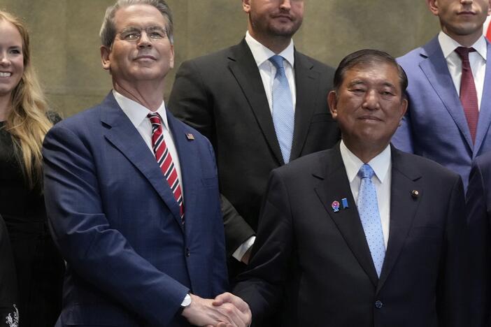 Japanese Prime Minister Shigeru Ishiba, right, shakes hands with U.S. Treasury Secretary Scott Bessent before their meeting at the prime minister's office in Tokyo on July 18, 2025.