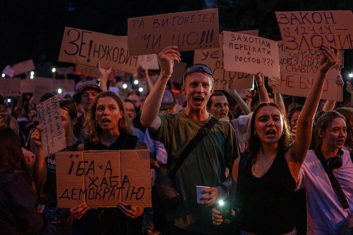 People chant while holding banners during a protest against a law targeting anti-corruption institutions in central Kyiv, Ukraine, on Tuesday.