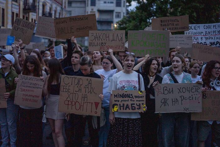 Protestant chant while holding banners that read "I stand for you, and for those who are on the frontline", "Do you want it like in Russia", "Stop robbing our future" during a protest against a law targeting anti-corruption institutions in central Kyiv, Ukraine on Tuesday.