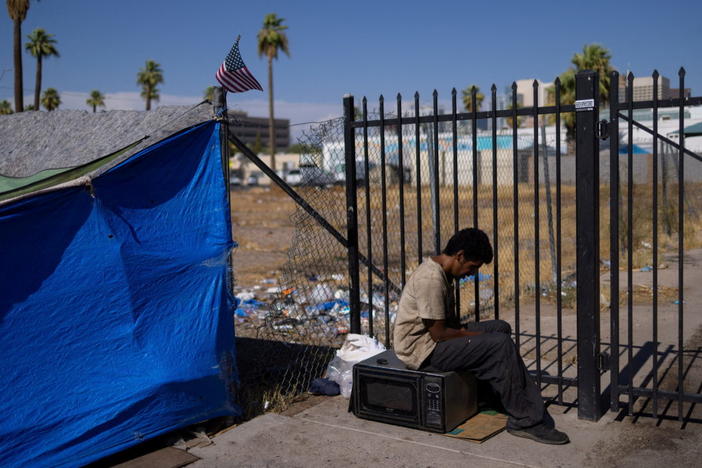 An unhoused man sits by a tent during a 27 days long heat wave with temperatures over 110 degrees Fahrenheit (43 degrees Celsius), in Phoenix, Arizona, U.S., July 26, 2023. Photo by Carlos Barria/REUTERS