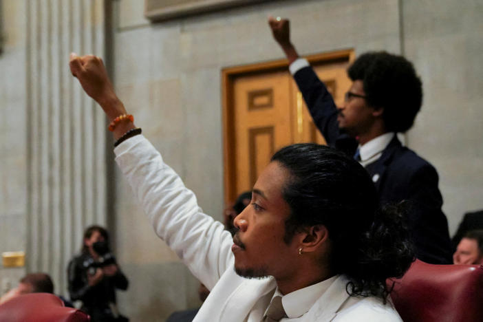 Tennessee Rep. Justin Pearson and Rep. Justin Jones raise their fists as a video of last week's gun control demonstration at the statehouse is screened and Republicans who control the Tennessee House of Representatives prepare to vote on whether to expel them for their role in it, in Nashville, Tennessee, April 6, 2023. Photo by Cheney Orr/REUTERS