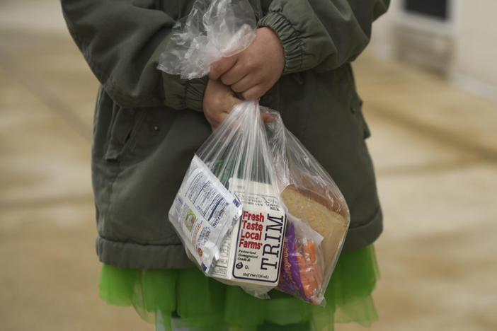 West Reading, PA - March 17: Myah Abeloff, 8, holds a packed lunch and breakfast as the Wyomissing Area School District handed out lunches (and breakfasts) for the first time Tuesday. (Photo by Lauren A. Little/MediaNews Group/Reading Eagle via Getty Images)