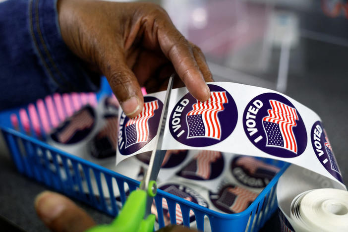 A poll worker prepares "I voted" stickers for voters at the City Clerk's Office ahead of the midterm election in Lansing, Michigan, U.S., November 7, 2022. Photo by Evelyn Hockstein/REUTERS