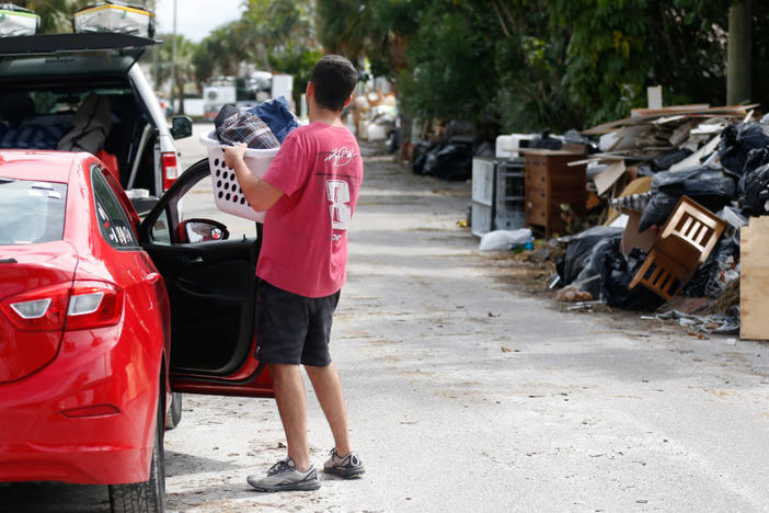 Sam Grande carries his belongings as he prepares to evacuate his home before the arrival of Hurricane Milton, St. Pete Beach, Florida, on Oct. 7, 2024. Photo by Octavio Jones/ Reuters
