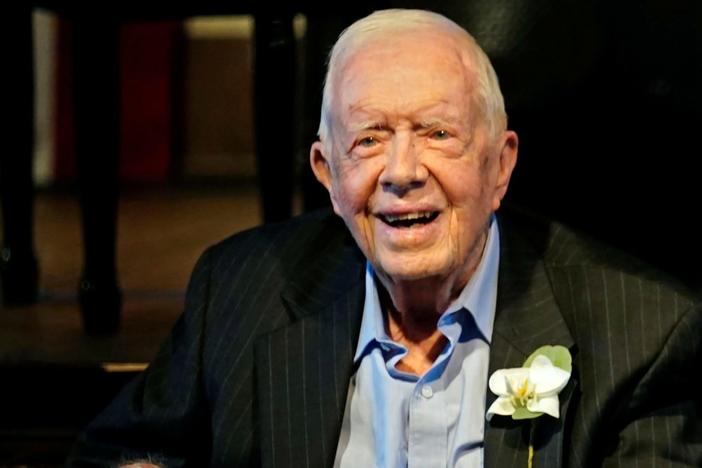 Former President Jimmy Carter smiles as his wife, former first lady Rosalynn Carter, speaks during a reception to celebrate their 75th wedding anniversary in Plains, Georgia, July 10, 2021. Photo by John Bazemore/Pool via REUTERS