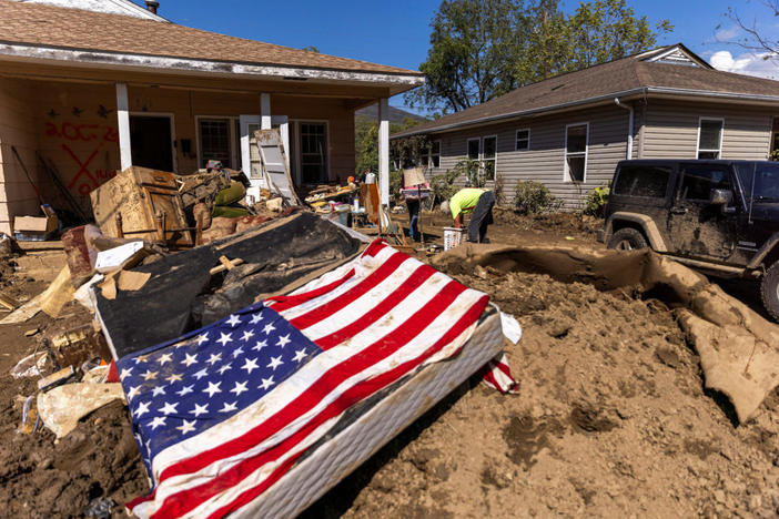 A resident cleans his home covered in mud, following the passing of Hurricane Helene, in Swannanoa, North Carolina, U.S., October 7, 2024. REUTERS/Eduardo Munoz