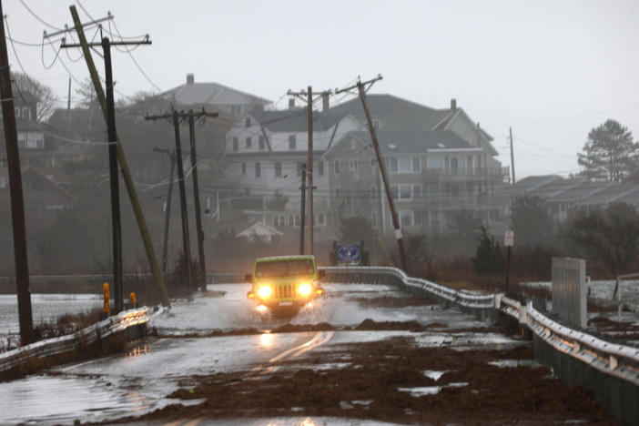 A driver makes their way through a flooded street at high tide during a winter storm in Gloucester, Massachusetts, Dec. 23, 2022. Photo by Brian Snyder/REUTERS