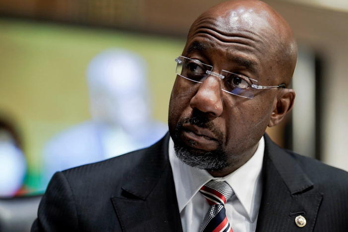 U.S. Senator Raphael Warnock (D-GA) listens to Dr. Philip Nathan Jefferson, of North Carolina, nominated to be a Member of the Board of Governors of the Federal Reserve System, during a Senate Banking, Housing and Urban Affairs Committee confirmation hearing on Capitol Hill in Washington, D.C., U.S., February 3, 2022. REUTERS/Ken Cedeno/Pool