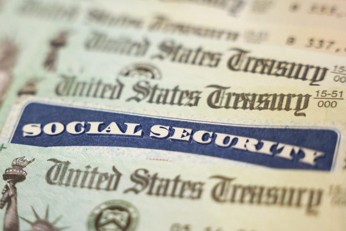 WASHINGTON, DC - OCTOBER 14: In this photo illustration, a Social Security card sits alongside checks from the U.S. Treasury on October 14, 2021 in Washington, DC. The Social Security Administration announced recipients will receive an annual cost of living adjustment of 5.9%, the largest increase since 1982. The larger increase is aimed at helping to offset rising inflation. Photo illustration by Kevin Dietsch/Getty Images