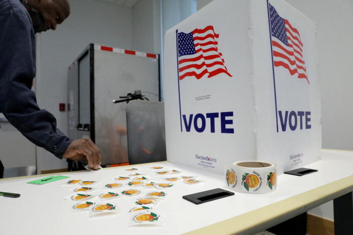 A man collects "I voted" sticker in Fulton County during the primary election in Atlanta, Georgia, U.S. May 24, 2022. REUTERS/Dustin Chambers