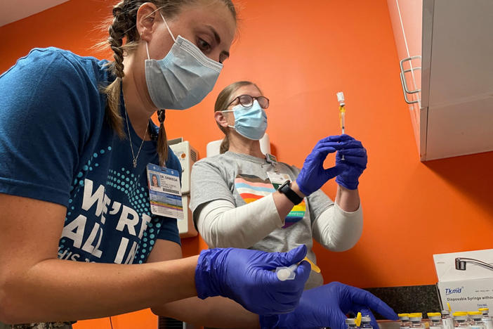 Dr. Emily Drwiega from the University of Illinois Health and Maggie Butler, a registered nurse, prepare monkeypox vaccines at the Test Positive Aware Network nonprofit clinic in Chicago, Illinois, U.S., July 25, 2022. REUTERS/Eric Cox