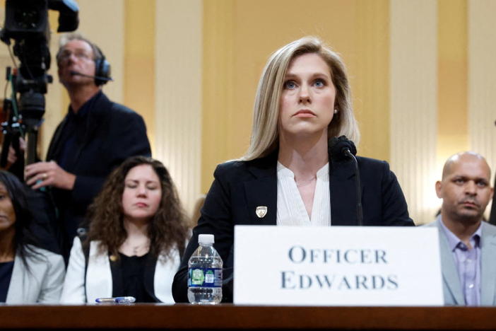 U.S. Capitol Police Officer Caroline Edwards testifies before the U.S. House Select Committee to Investigate the January 6 Attack on the United States Capitol with Sandra Garza, partner of Brian Sicknick, and U.S. Capitol Police Officer Sgt. Aquilino Gonell in the back, on Capitol Hill in Washington, U.S., June 9, 2022. Photo by Jonathan Ernst/REUTERS