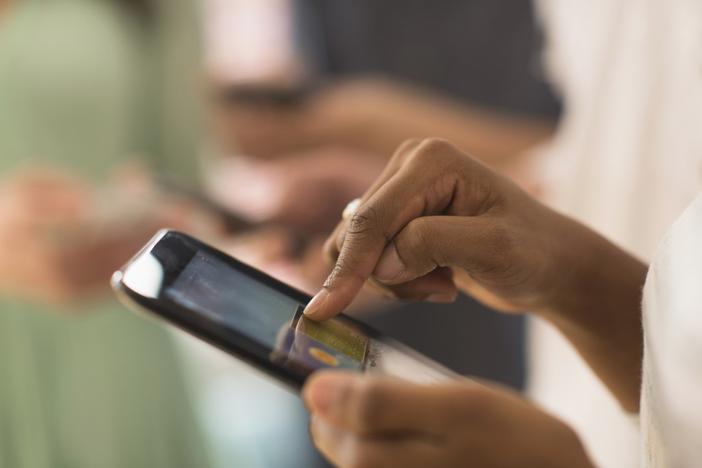 Close up of woman using cell phone touch screen