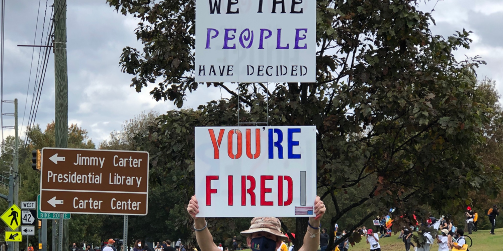 Women holds up you're fired sign