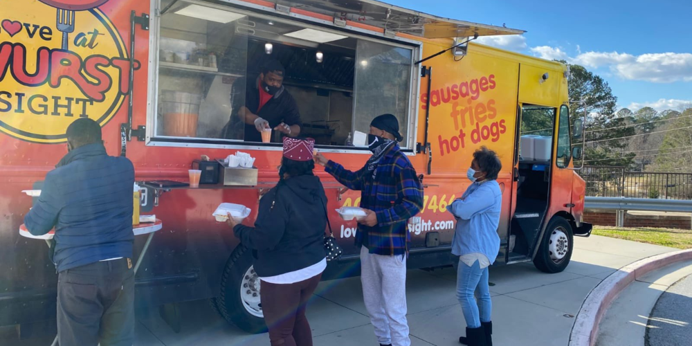 Voters ordering food from food truck at polling place.