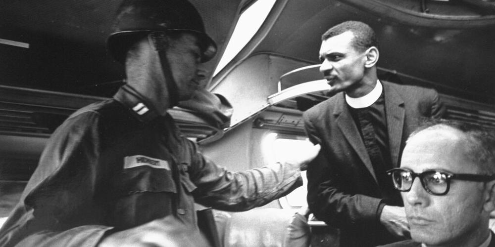 C.T. Vivian speaks to a soldier on a bus.