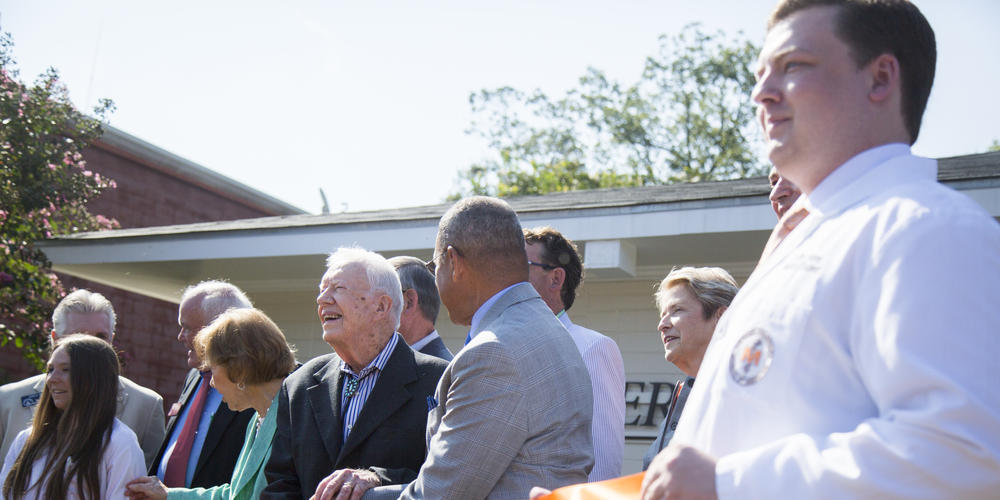 Jimmy Carter and Rosalynn Carter help cut the ribbon at their new clinic on August 22, 2018.