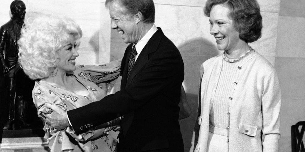 U.S. President Jimmy Carter and Dolly Parton embrace in the receiving lime at the White House in Washington, Tuesday, Oct. 2, 1979. President Carter hosted a luncheon in the Executive Mansion for a group of country music entertainer.