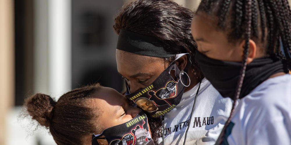 Ahmaud Arbery’s aunt Carla Arbery comforts Aailyah Trimmings, 9, and Alyria Carter, 10, outside of the Glynn County Courthouse in Brunswick on Oct. 16.