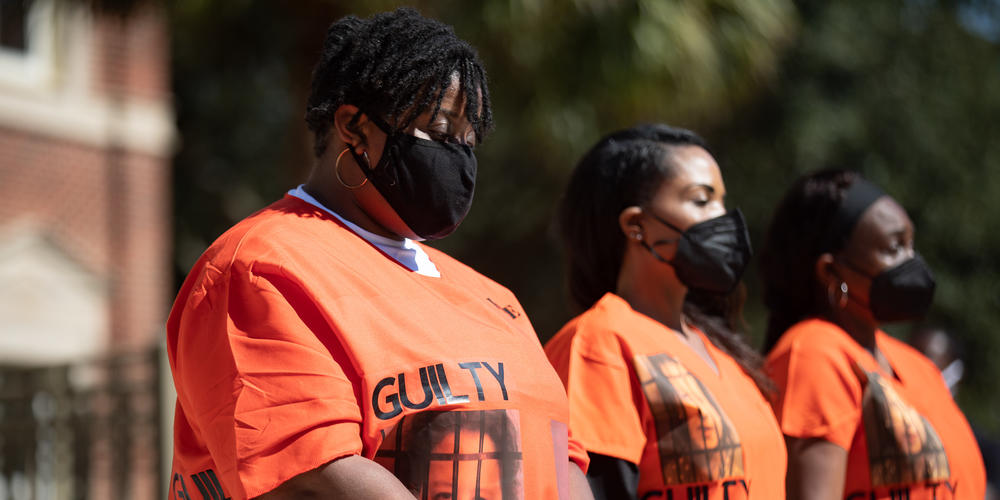 Outside of the Glynn County Courthouse, Ahmaud Arbery's aunt, Thea Brooks, joins a group during a demonstration calling for the conviction of the three men who face charges in the death of Ahmaud Arbery and other county officials they say were complicit in his death.