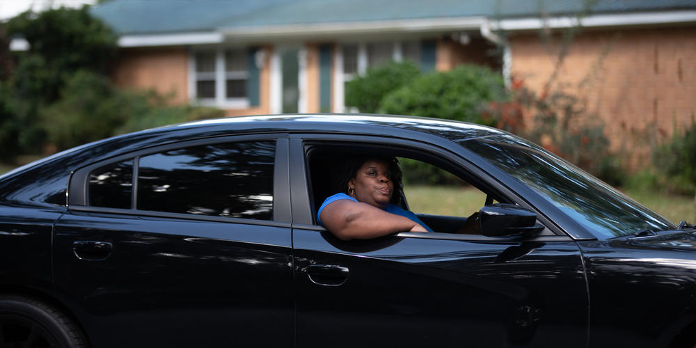 Ahmaud Arbery’s Aunt, Theawanza Brooks, rides in a car down Satilla Drive, the street where her nephew took his last breath, during a car procession in Brunswick on Oct. 16.