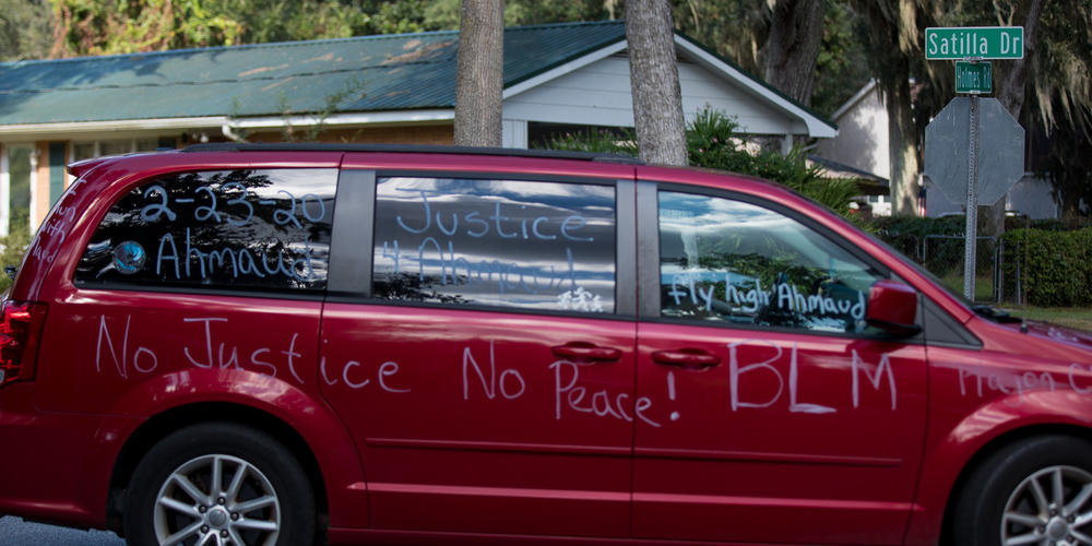 A car procession makes its way through the Satilla Shores neighborhood in Brunswick in honor of Ahmaud Arbery, who was killed in the location in February 2020.