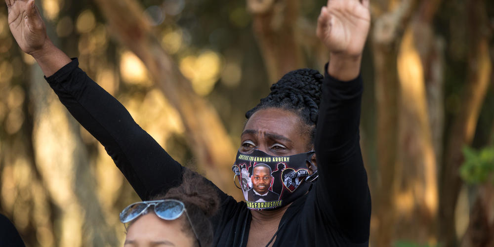 Ahmaud Arbery’s aunt Carla Arbery prays during a vigil outside of the Glynn County Courthouse in Brunswick on Oct. 17, 2021.