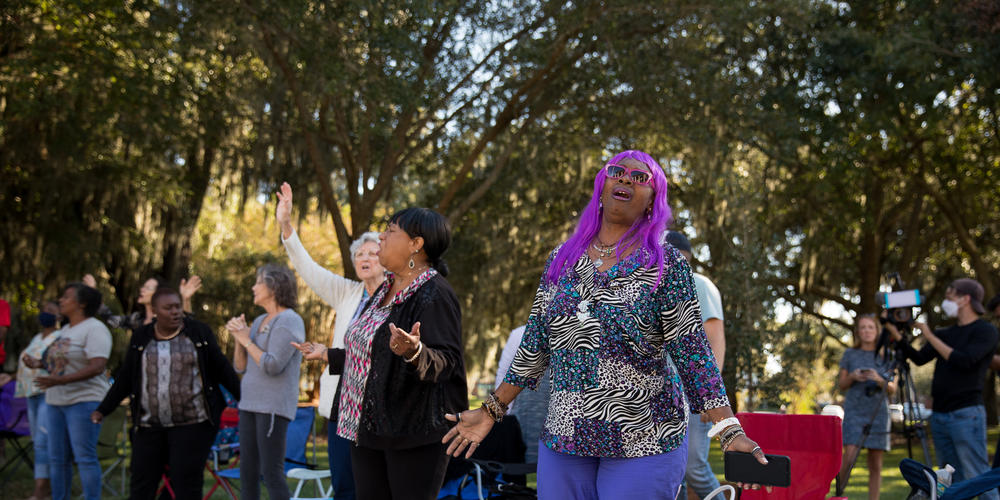 Friends and family of Ahmaud Arbery pray during a vigil outside of the Glynn County Courthouse in Brunswick on Oct. 17, 2021.