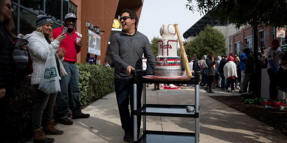 An Atlanta Braves World Series Champions cake is rolled through the crowd outside of Truist Park ahead of the victory parade on Nov. 5.