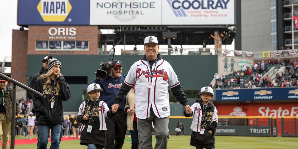 Atlanta Braves manager Brian Snitker walks onto Truist Park field with his family during the World Series victory celebration on Nov. 5.