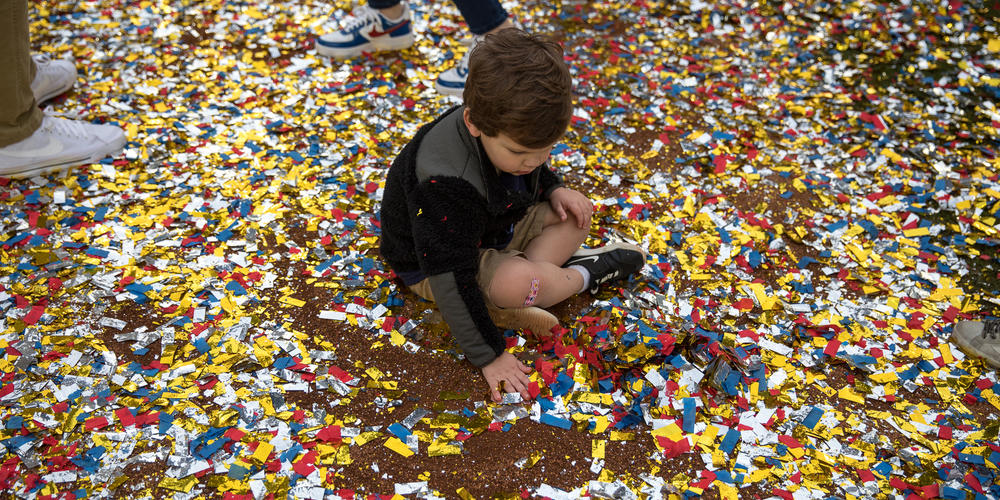 A young Braves fan plays in the fallen confetti during the team’s World Series victory celebration at Truist Park on Nov. 5.