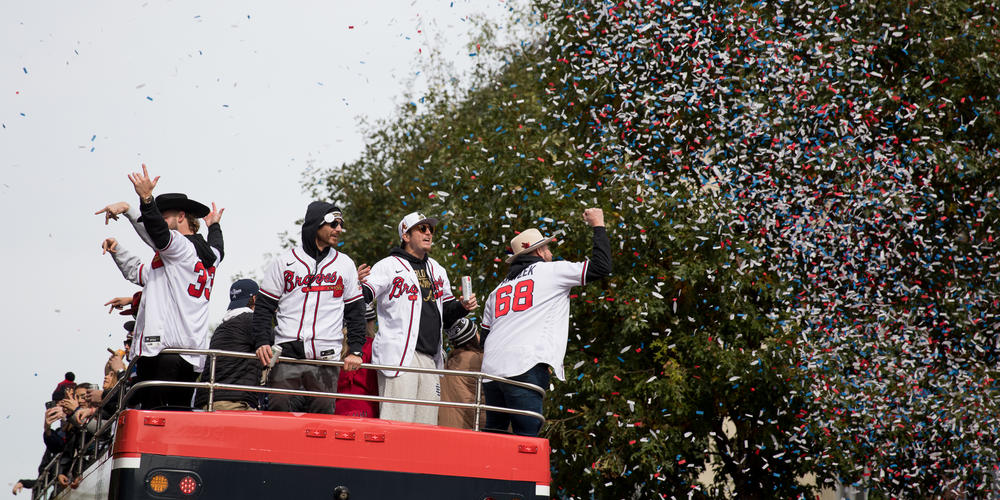 Atlanta Braves players celebrate under a shower of confetti as they travel through The Battery outside Truist Park during their victory parade on Nov. 5.