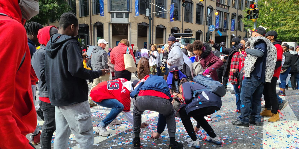Fans pick up confetti on the streets of Atlanta, because "it's World Series confetti" of course.