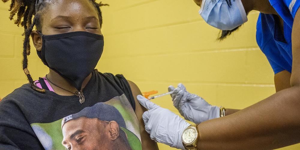 Bibb County middle school student Sade Veal gets her first dose of the Pfizer COVID vaccine at a back to school event sponsored by Bibb County Schools in 2021. 