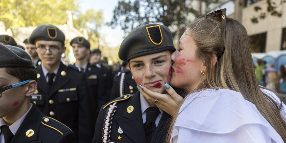 A member Benedictine Military School is kissed while marching in the St. Patrick's Day parade, Thursday, March 17, 2022, in historic downtown Savannah, Ga. The South's largest St. Patrick's Day celebration made a big comeback following a two-year virus hiatus.