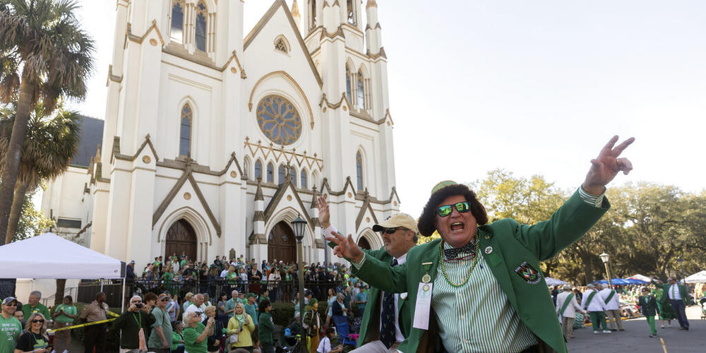 Past Grand Marshall Michael W. Roush, Sr., right, cheers at the crowd during the St. Patrick's Day parade, Thursday, March 17, 2022, in historic downtown Savannah, Ga. The South's largest St. Patrick's Day celebration made a big comeback following a two-year virus hiatus.