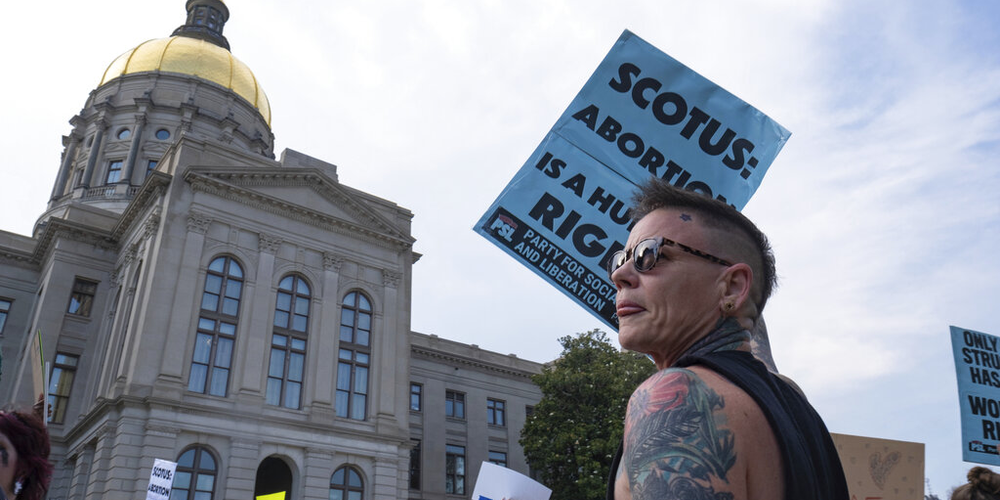 People gather in front of the Georgia State Capitol in Atlanta on Friday, June 24, 2022, to protest the Supreme Court decision striking down Roe v. Wade.