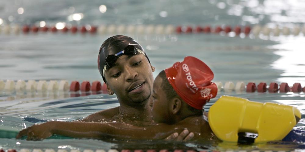 In this Sept. 25, 2007, file photo Olympic swimmer Cullen Jones, left, teaches water safety to Jaquil Wise, 7, at the pool in Newark, N.J., where Jones learned to swim. Jones won a gold medal at the Olympics on the U.S. men's 400 meter relay team at the Beijing Olympics Monday, Aug. 11, 2008.