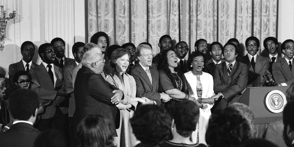 The White House was the scene of a reception to honor friends of the Martin Luther King Jr. Center for Social Change in Washington on Oct. 3, 1978. Singing at the reception are from left, Dr. Martin Luther King Sr., Rosalynn Carter, President Jimmy Carter, Coretta Scott King, Christine Parris King, sister of the late Dr. King, and Andrew Young, U.N. Ambassador. 
