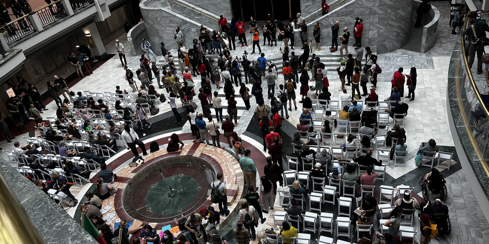 More than 350 people signed up to speak in a period of public comment at Atlanta City Hall on June 5, 2023 as a City Council meeting and vote held in the chambers is broadcast to the atrium of the building.